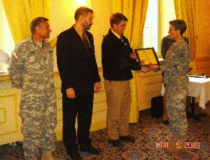 Col. Fraley (r) presents lifetime membership plaques to (l-r) Lt. Col. Raza Mohsin, USA; Robert J. Maldonado; and William Hardy at the March meeting.