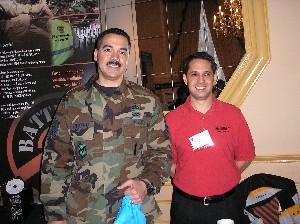 Master Sgt. Rob Maldonado (l), USAF, the Stuttgart Chapter's Young AFCEAN and Scholarship VP, shows his enthusiasm at the Winter Technology Expo, where he enjoyed information provided by an unidentified rep from Juniper. 
