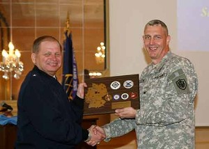 Col. Curry (r), presents Brig. Gen. Thomas J. Verbeck, USAF (l), with an 