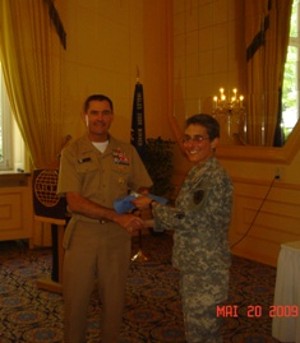 Col. Fraley thanks Fleet Master Chief Petty Officer Roy M. Maddocks Jr., USN, senior enlisted adviser, U.S. European Command, for serving as the keynote speaker during the presentations in May. He emphasized the importance of education and of staying current with technological advancements.