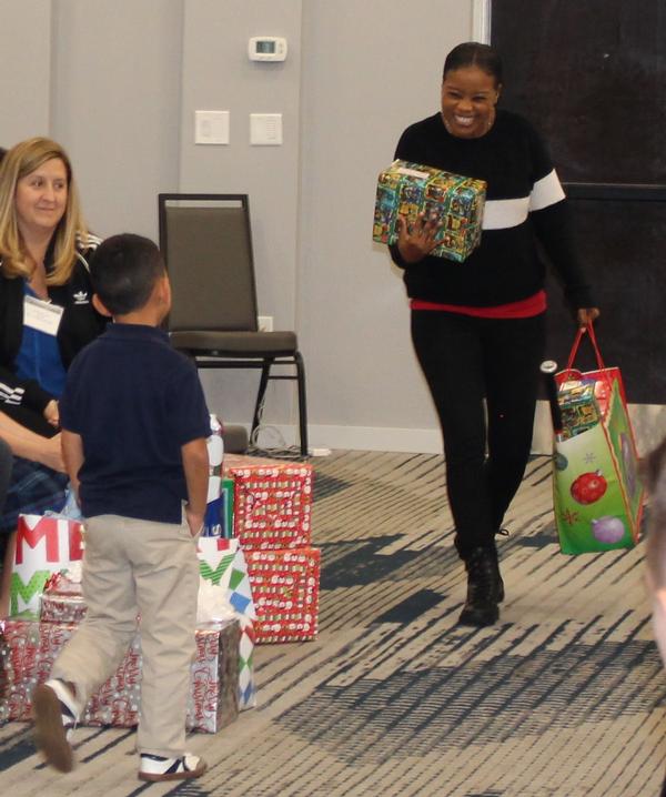 Chapter attendee presents gifts to their "Secret Santa" child.