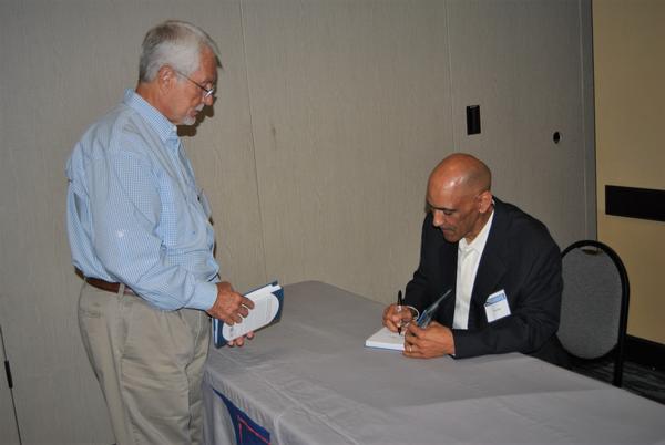 At the May luncheon, Coach Tony Dungy signs a copy of his latest book, The Soul of a Team.