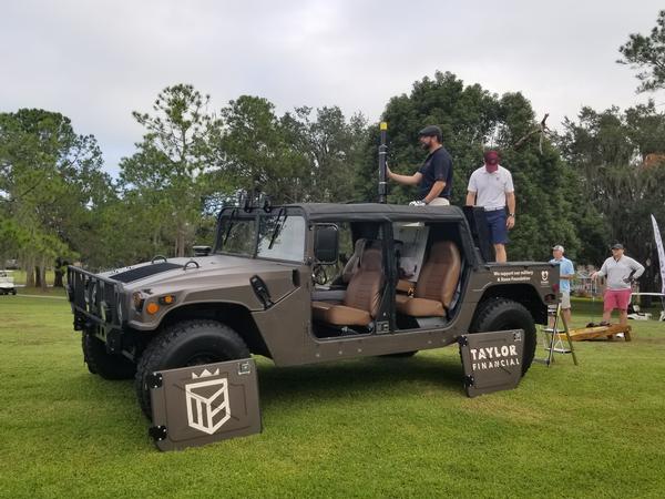 Taylor Financial, sponsor of the golf cannon, arrives at the November event with their Humvee.