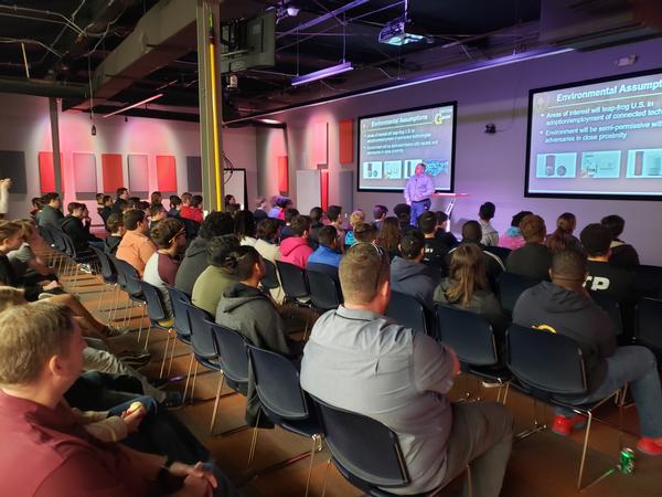 Students listen to the presentation given by Pablo Breuer, innovation officer, Donovan Group, U.S. Special Operations Command, during the November event.