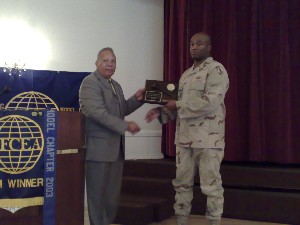 Lt. Col. Randall Bland, USA, outgoing chapter president, receives the meritorius service award from Lou Ramos, Western Florida regional vice president, in June.