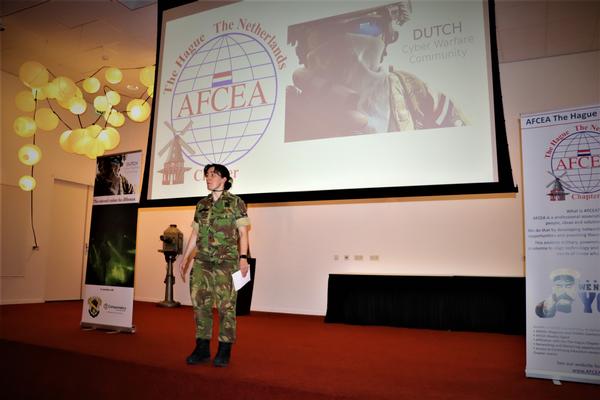 Army Col. Mietta Groeneveld, chapter president, speaks to a well-attended symposium in March.