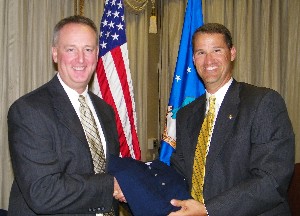 Bill Marion (r), chapter president, presents Stan C. Newberry, director, Air Force Command and Control Integration Center, with a chapter polo shirt at the June meeting.