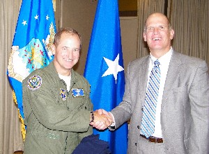 Ken Hirlinger (r), chapter president, presents Brig. Gen. John Ranck, USAF, director, Warfighter Systems Integration Directorate, with a chapter polo shirt following the general's speech at the October meeting.