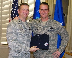 Col. Glenn Powell, USAF (l), presents Brig. Gen. Peter E. Gersten, USAF, director, plans and programs, Headquarters Air Combat Command, with a chapter polo shirt follow the general's speech in February.