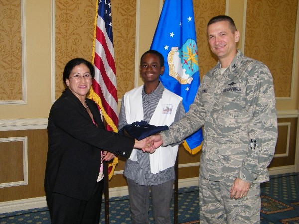 In September, Col. Glenn Powell, USAF (r), chapter vice president, presents Teresa M. Salazar with a chapter polo shirt, which she then presented to Cameron Mays, the local Mini Unmanned Aerial Vehicle (UAV)Competition winner.