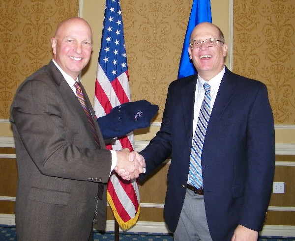 Ken Hirlinger (r), chapter president, presents Tom Wojszynski, Google Department of Defense Team, with a chapter polo shirt in November.