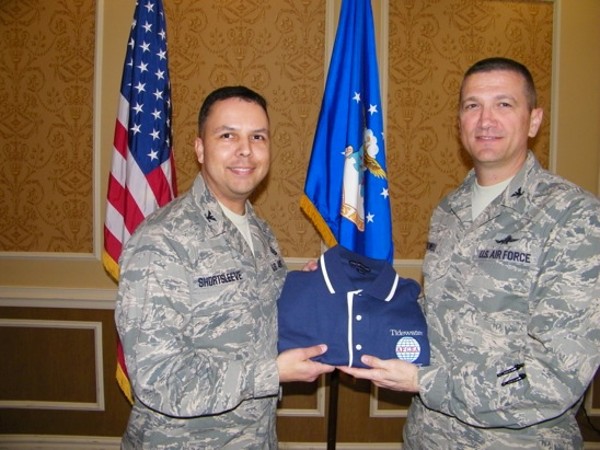 In March, Col. Glenn Powell, USAF (r), chapter vice president, presents a polo shirt to Col. Patrick Shortsleeve, USAF, commander, 497th Intelligence, Surveillance and Reconnaissance Group, Langley Air Force Base.