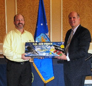 Mario Manfre (l) of the Air Combat Command Communications Support Squadron wins the scholarship drawing in March. Ken Hirlinger, chapter president, presents him with a U.S. Air Force poker chip set as his prize.