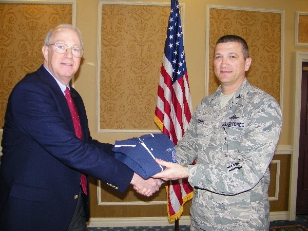 Col. Glenn Powell, USAF (r), chapter president, presents Michael C. Smith, a professor from the University of Virginia (UVA) Department of Systems and Information Engineering, with a chapter shirt following his presentation in January.