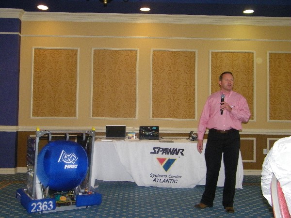 Matt Wilbur, the Menchville High School robotics coach, displays a robot that competed in national-level events in May.