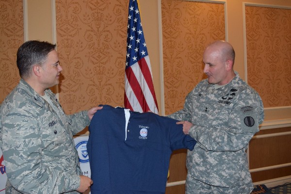 Chapter President Col. Rick Folks, USAF (l), presents Maj. Gen. William Hix, USA, deputy director, Army Capabilities Integration Center, U.S. Army Training and Doctrine Command (TRADOC), the chapter polo shirt at the November luncheon.