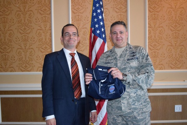 Col. Rick Folks, USAF, chapter president, presents Gunnar Hellekson, the chief strategist for Red Hat's U.S. Public Sector group, with a chapter polo shirt at the March luncheon.