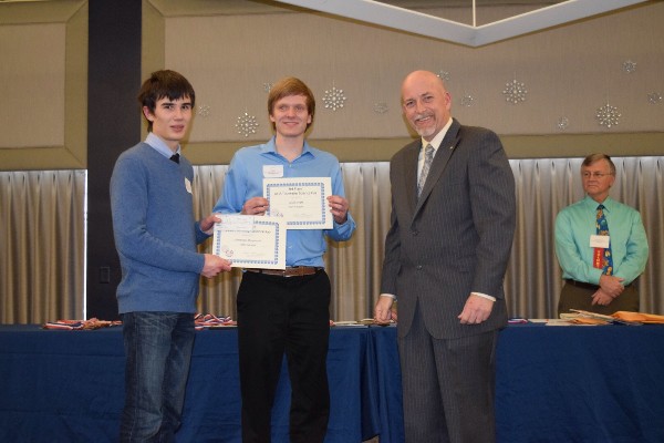 Rick Beard (r), the chapter's science fair point of contact, helps recognize the third place team at the Tidewater Science and Engineering Fair: Alexander Khlopenkov (l) and Jason Knight.