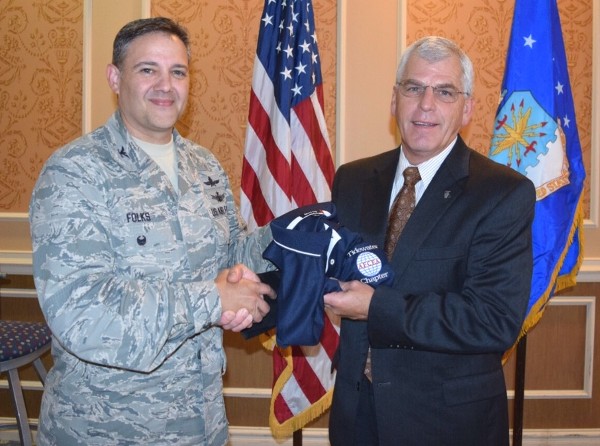 Chapter President Col. Rick Folks, USAF (l), presents Randall McFadden, director, Acquisition Management and Integration Center (AMIC), Langley Air Force Base, Virginia, a chapter polo shirt at the November luncheon.