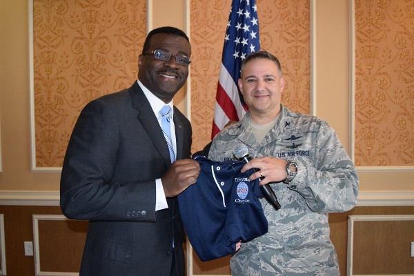 Chapter President Col. Rick Folks, USAF (r) presents Jeff Johnson, director of the Virginia Tech Corporate Research Center with a chapter polo shirt at the luncheon in February.