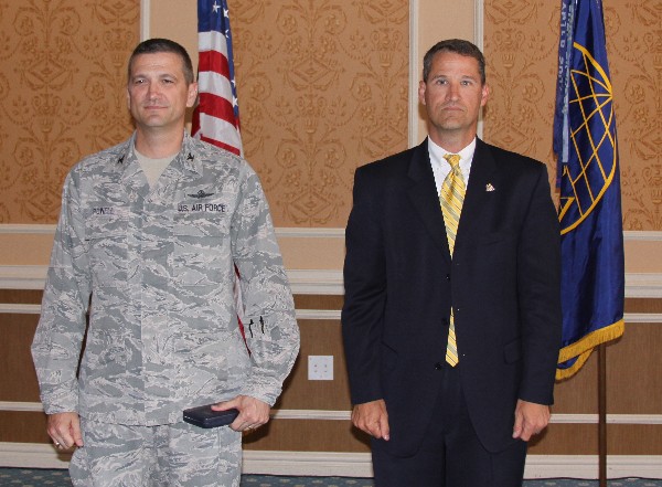 During the June luncheon, Bill Marion (l), past chapter president and chief technical officer, headquarters Air Combat Command Communications and Information, Langley Air Force Base, receives the Air Force Meritorious Civilian Service Award from Col. Glenn Powell, USAF, chapter vice president.
