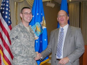 In October, Hirlinger (r) honors Senior Airman Patrick Weller, USAF, with the chapter's AFCEAN of the Month Award.