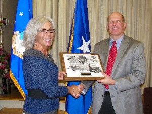Ken Hirlinger, chapter president, presents Rhonda Richardson, Air Combat Command/A-6C, with the chapter's AFCEAN of the Month Award for February in recognition of her efforts as the chapter science, technology, engineering and mathematics representative for unmanned aerial vehicles.