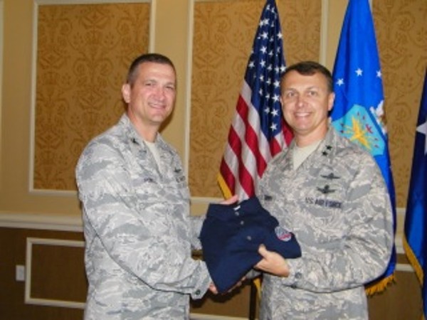 Col. Glenn Powell, USAF (l), chapter vice president, presents Maj. Gen. Earl D. Matthews, USAF, director, cyberspace operations, Office of Information Dominance and Chief Information Officer, Office of the Secretary of the Air Force, with a chapter polo shirt in July.