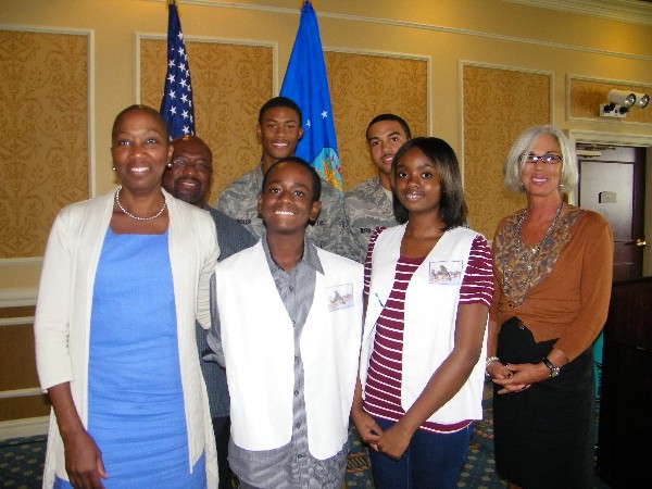 Mays (front row, 2nd from l), winner of a local mini unmanned aerial vehicle competition, is recognized in September with support from his sister Mercedes (front row, 2nd from r), who is also a member of the “Stepping Up America” aviation and robotics program. Also on hand for the presentation are Dr. Angela Goodloe (l), director of Stepping Up America; Rhonda Richardson (r), chapter STEM UAV lead; and chapter event judges (back row, l-r) William Benson, Airman 1st Class Braxton Ward, USAF, and Airman 1st Class Corey Kinsler, USAF.