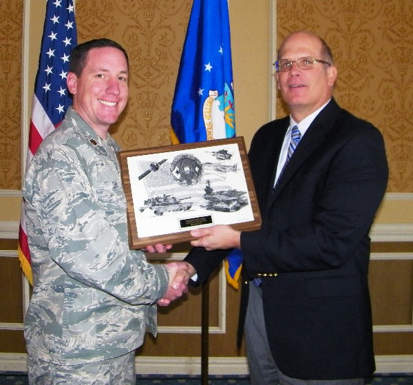 At the November luncheon, Hirlinger (r) recognizes Maj. Mike Zink, USAF, Air Combat Command/A6C, for his selection as the chapter's AFCEAN of the Month.