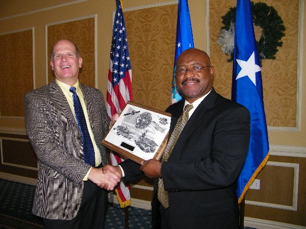 Ken Hirlinger (l), chapter president, congratulates William Benson, Headquarters Air Combat Command, for his selection as the December AFCEAN of the Month.