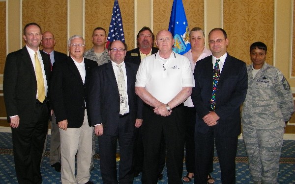 TIDEWATER—Chief Master Sgt. Suzanne Clemons, USAF, chapter director of member services, and chapter leadership recognized long-time AFCEA Members during the July luncheon.  Front row: (l-r) Marty Edmonds (30 Years); Stan Howard (25 Years); John Dahlgren (20 Years); Art Glatt (25 Years); Steve Simkins (20 Years); and Chief Master Sgt. Clemons.  Back row (l-r): Ken Hirlinger, president; Col Glenn Powell, USAF, vice president, military; Steve Kelley (25 Years) and Melissa Errett, chapter vice president, industry.