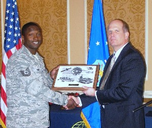 In March, Hirlinger (r) presents the chapter's AFCEAN of the Month Award to Tech Sgt. Charles Smalls, USAF.