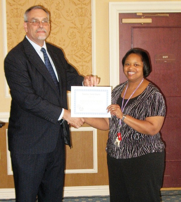 In April, Mike Mitchell, chapter director of science, technology, engineering and mathematics (STEM), presents an award to the chapter's featured STEM teacher: Tracey Jones, Heritage High School, Newport News, Virginia. Jones has been teaching biology and chemistry at Heritage High School for almost 11 years. She has a bachelor's of science from Norfolk State University's Dozoretz National Institute for Math and Applied Sciences and a master of science in microbiology at Eastern Virginia Medical School. Jones has been in a collaborative setting with special education students for almost five years.
