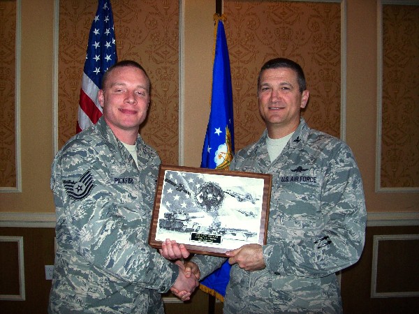 In November, Col. Powell (r) presents the November AFCEAN of the Month plaque to Tech. Sgt. Alan Pickford, USAF.
