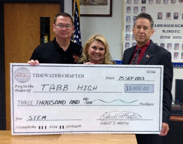 In November, Ed Crosby (r) of BAH presents Tabb High School's Cyber Patriot Team Commander Gary Wooten (l) and Principal Angela Seiders with a $3,000 AFCEA sponsored grant.