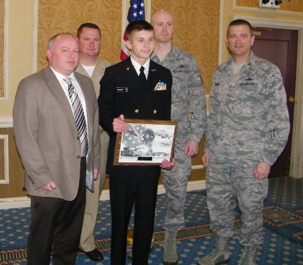 During the chapter's January luncheon, Bryan Dunsmore (c) displays his AFCEAN of the Month plaque along with (l-r) Tom Harris, DRC; Cmdr. Gary Wooten, Tabb High School Junior ROTC; Master Sgt. Matthew Dunsmore, USAF, Bryan's father; and Col. Powell.