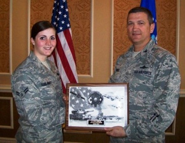 Col. Powell presents the March AFCEAN of the Month Award to Airman 1st Class Kylie Subjinske, USAF, Air Combat Command Computer Support Squadron, who distinguished herself by providing outstanding support during the Christopher Newport University Cyber Symposium.