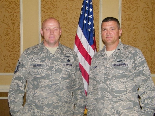 Col. Powell (r) congratulates Master Sgt. Scott Ferrell, USAF, for his selection as AFCEAN of the Month for May.