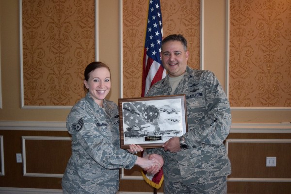 Col. Folks presents the March AFCEAN of the Month Award to Staff Sgt. Jessica Grabinski, USAF, 10th Intelligence Squadron/SCOI.