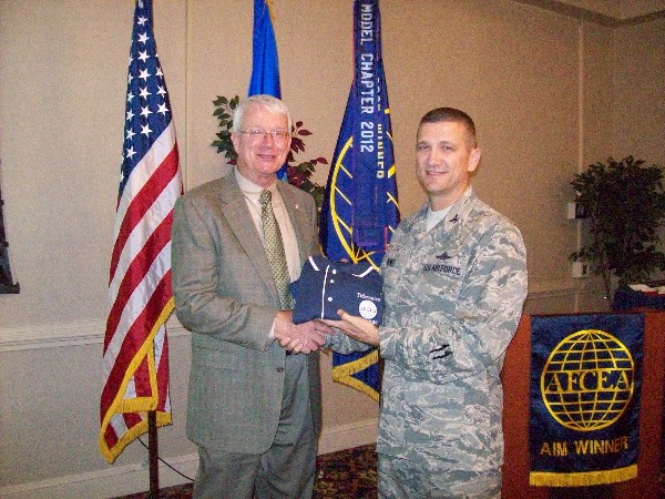 Lt. Gen. William Donahue, USAF (Ret.) (l), receives a chapter polo shirt from Col. Powell as a token of appreciation for being the keynote speaker at the chapter's Volunteer Appreciation Social in September.