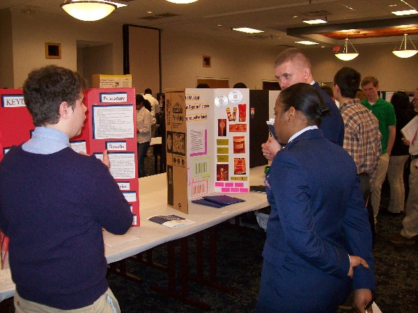 Chapter judges Lt. Salandy and Capt. Wachlin examine a contestant's entry during the Tidewater Science and Engineering Fair in March.