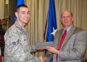 In February, Hirlinger (r) congratulates Senior Airman Patrick Weller, USAF, for his selection as a recipient of the Distinguished Young AFCEAN Award.