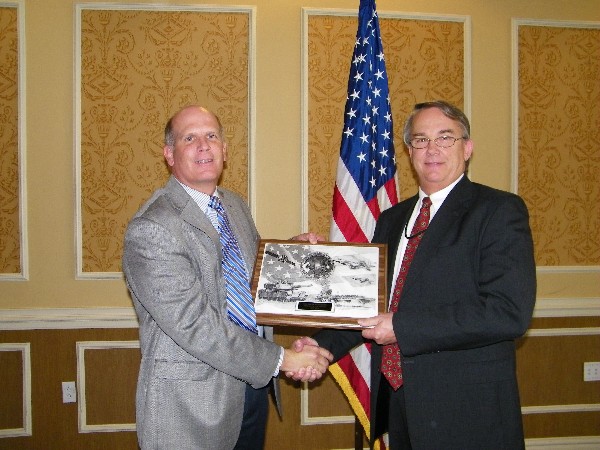 Ken Hirlinger, chapter president (l), congratulates Mark Peterson for his selection as the May AFCEAN of the Month recipient. Peterson was the point person for organizing support for the East: Joint Warfighting 2013 conference.