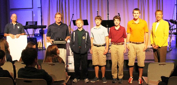 Tom Neighbors of Spectrum Corp presents $2,000 to Summit Christian Academy in November to support the integration of robotics and computer management into its STEM program.