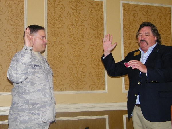 In May, Steve Kelley, AFCEA Virginia regional vice president (r) swears in Col Rick Folks, USAF, as the new chapter president.