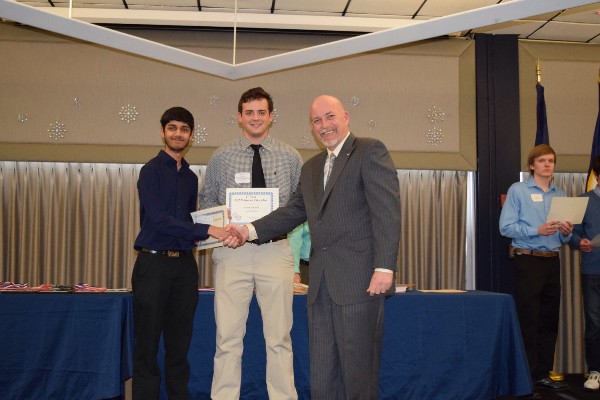 In March, Beard (r) presents Sahaj Bhatt (l) and William Brayshaw with the second place at the Tidewater Science and Engineering Fair.
