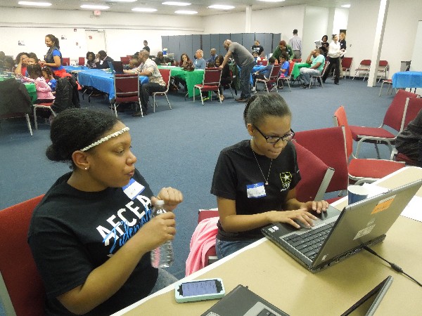 Airman 1st Class Herbert provides programming assistance to a student at the Hour of Code event in May.
