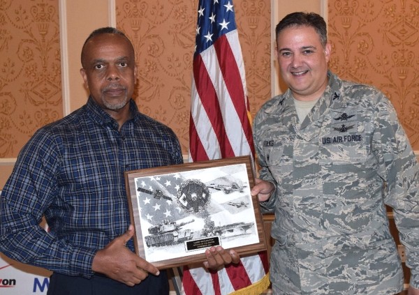 Col. Folks recognizes Larry Watlington (l), November's AFCEAN of the Month, for his work with chapter publicity at the November luncheon.