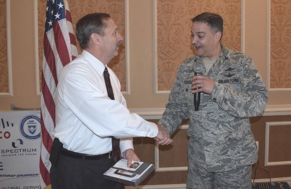 Col. Folks congratulates Tim Timmons (l) for winning a Nook Simple Touch during the November luncheon's scholarship raffle. The funds provide scholarships to local high school and college students.